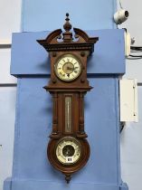 A walnut cased wall clock and barometer