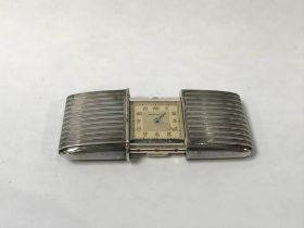 A silver Movado purse watch