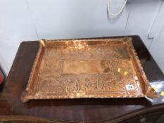 A large copper Arts and Crafts rectangular embossed tray, W 49cm