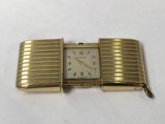 A gold Movado purse watch, hallmark on stand rubbed