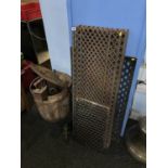 A cast iron wash tub, various flat irons and a selection of cast iron floor grills etc.