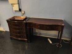 A reproduction mahogany serpentine chest of drawers and a side table