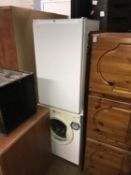 A tumble dryer and a small fridge