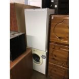 A tumble dryer and a small fridge