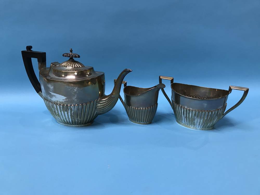 A silver three piece tea set, Walker and Hall, Sheffield, 1917, 36 ozs