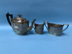 A silver three piece tea set, Walker and Hall, Sheffield, 1917, 36 ozs