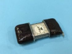 A silver and leather Movado purse watch