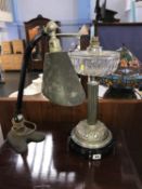 A retro angle poise lamp and an oil lamp