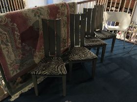 Four modern chairs, with faux zebra skin seats