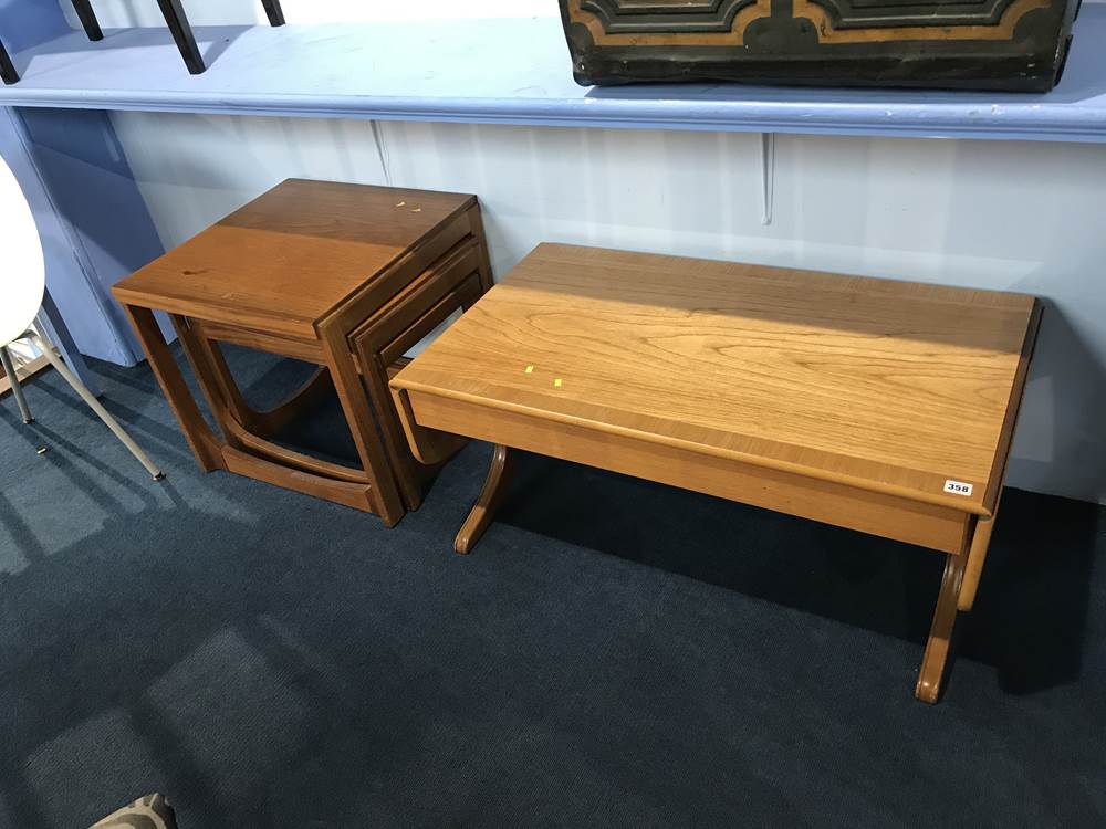 A teak nest of tables and a coffee table
