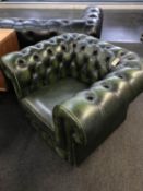 Two green Chesterfield club armchairs