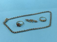 Two 9ct gold rings, a 9ct brooch and a chain
