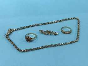 Two 9ct gold rings, a 9ct brooch and a chain