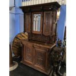 A Continental carved oak side cabinet