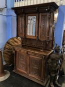 A Continental carved oak side cabinet