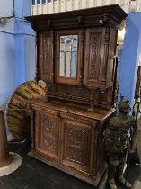 A Continental carved oak side cabinet