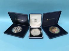 Three silver five ounce coins, 15oz, in display cases