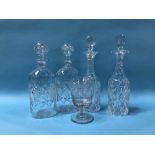 Two pairs of cut glass decanters and an etched wine glass