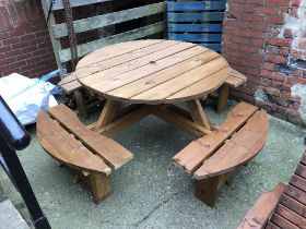 A large circular picnic bench with attached seats