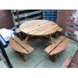 A large circular picnic bench with attached seats