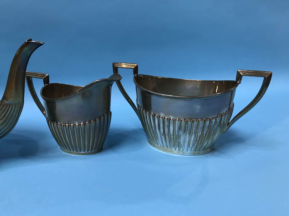 A silver three piece tea set, Walker and Hall, Sheffield, 1917, 36 ozs - Image 2 of 3