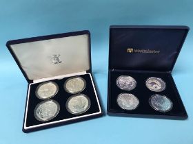 Eight silver one ounce pure coins in two presentation cases, including four Britannias, China etc