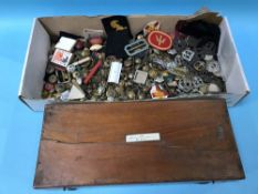 Large collection of cloth and brass badges, buttons, shoulder and cap badges etc.