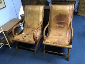 A pair of tan leather armchairs