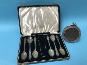 Set of silver spoons and a circular silver frame