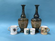 Pair of Royal Doulton stoneware vases and four Royal Worcester miniature cups