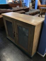 A light oak two door cabinet