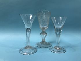 A 19th Century acid etched wine glass and two tear drop wine glasses