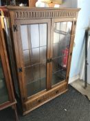Oak leaded bookcase with shelves