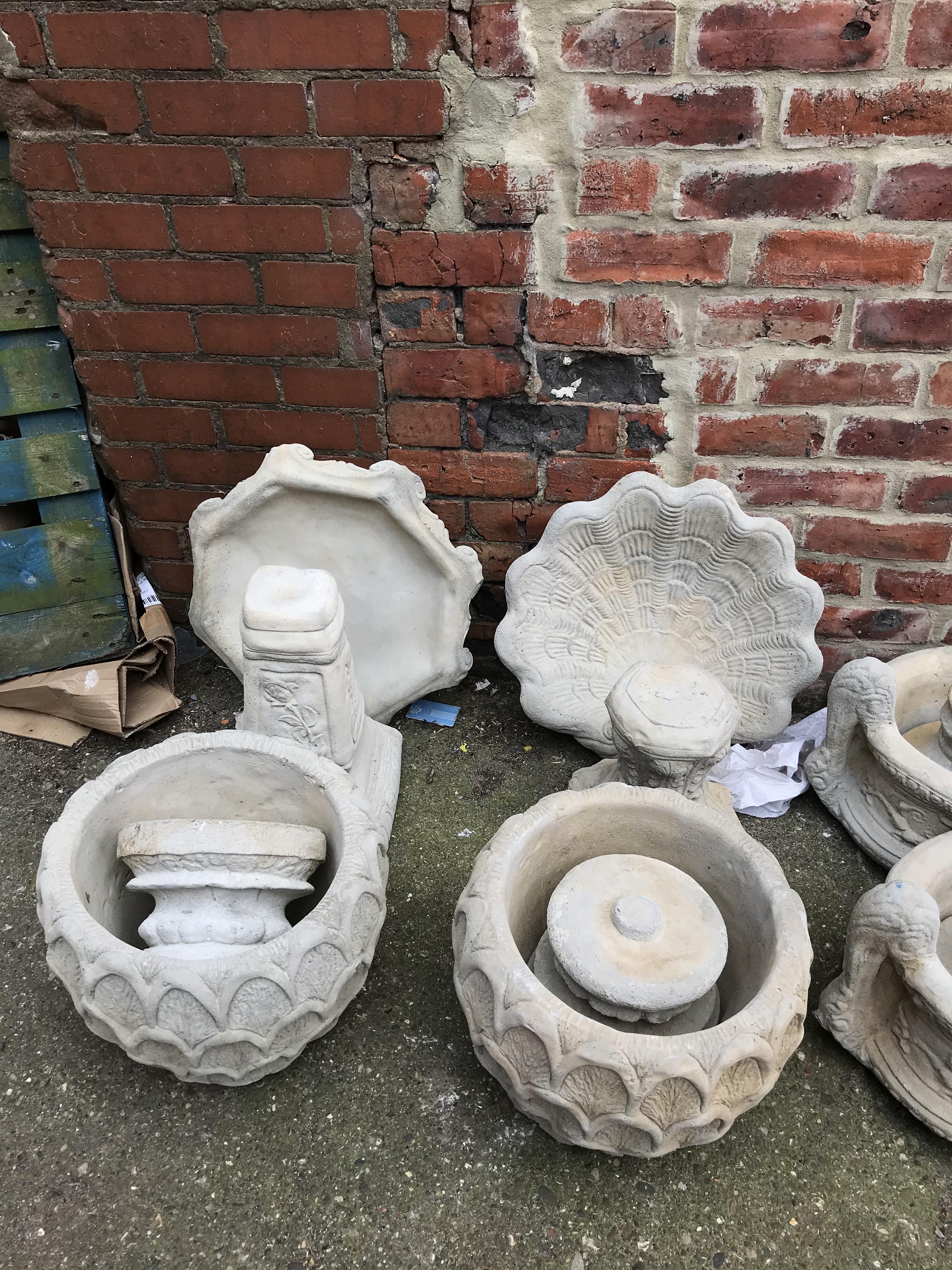 Garden statuary: Two bird baths and a pair of garden planters