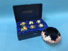 A small modern Moorcroft vase and a boxed set of six miniature Moorcroft vases