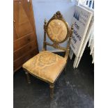 A gold coloured bedroom chair