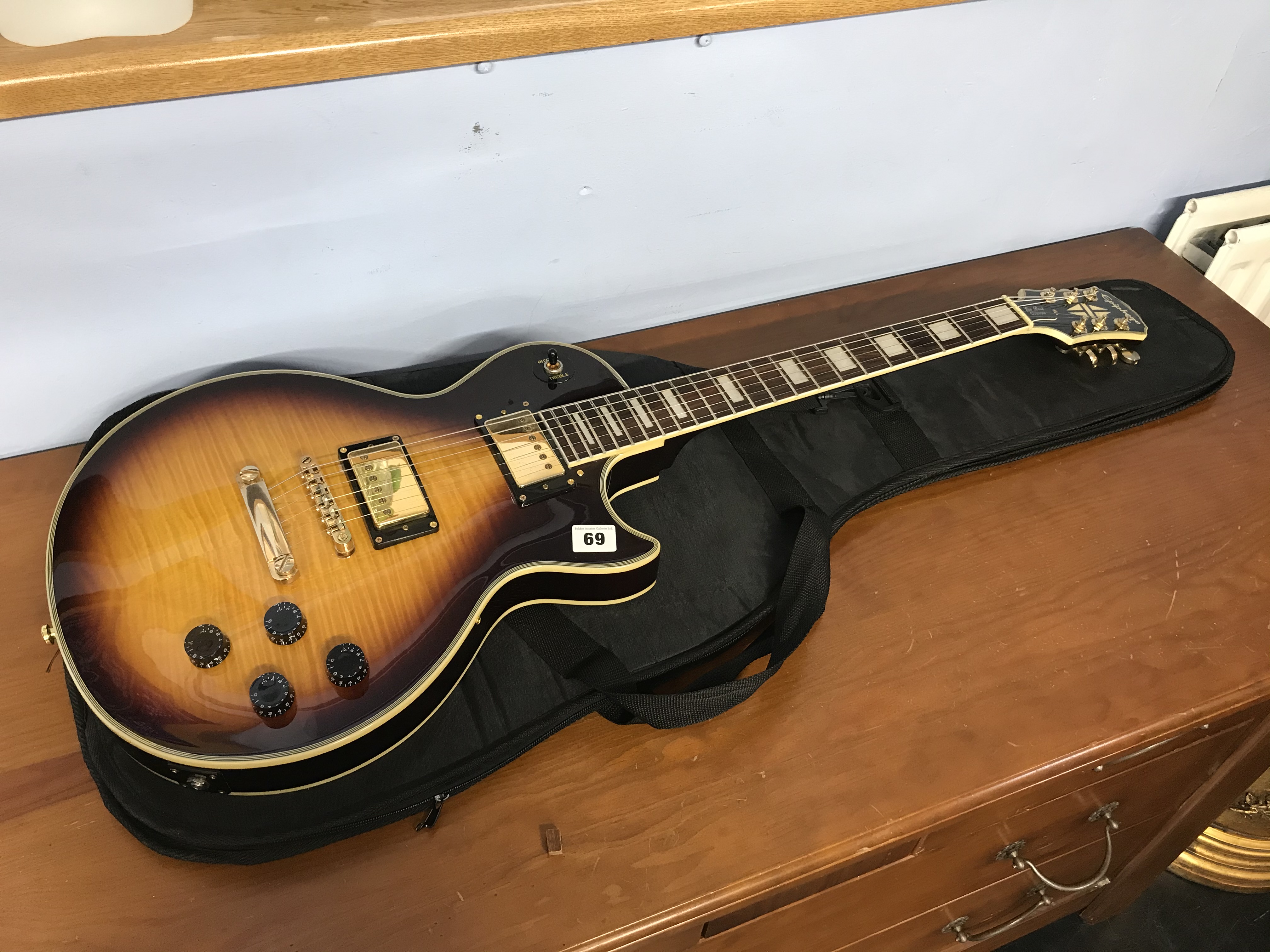 A Les Paul custom style guitar, with soft case