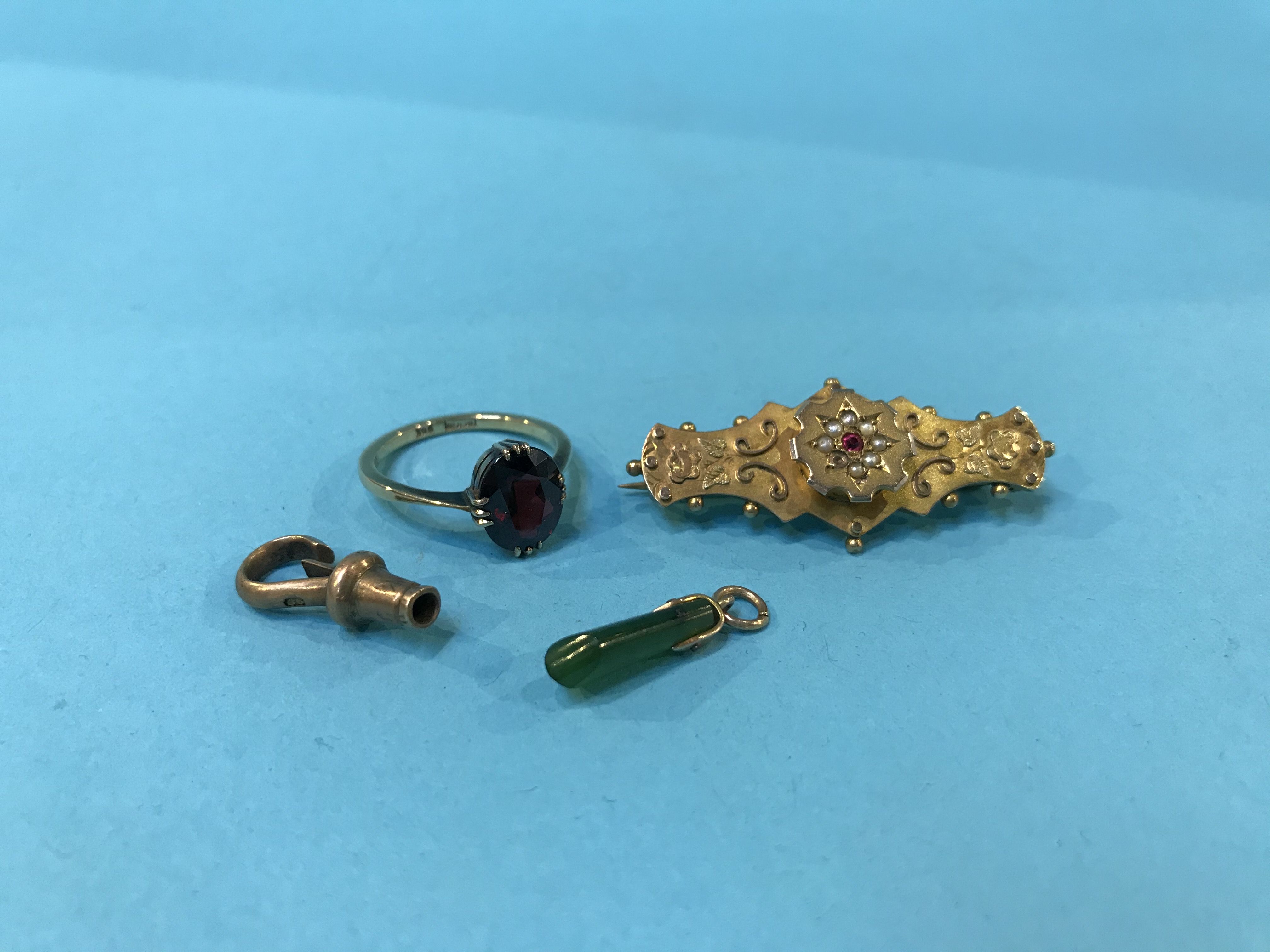 A 9ct ring, a brooch, a gold mounted jade pendant etc.