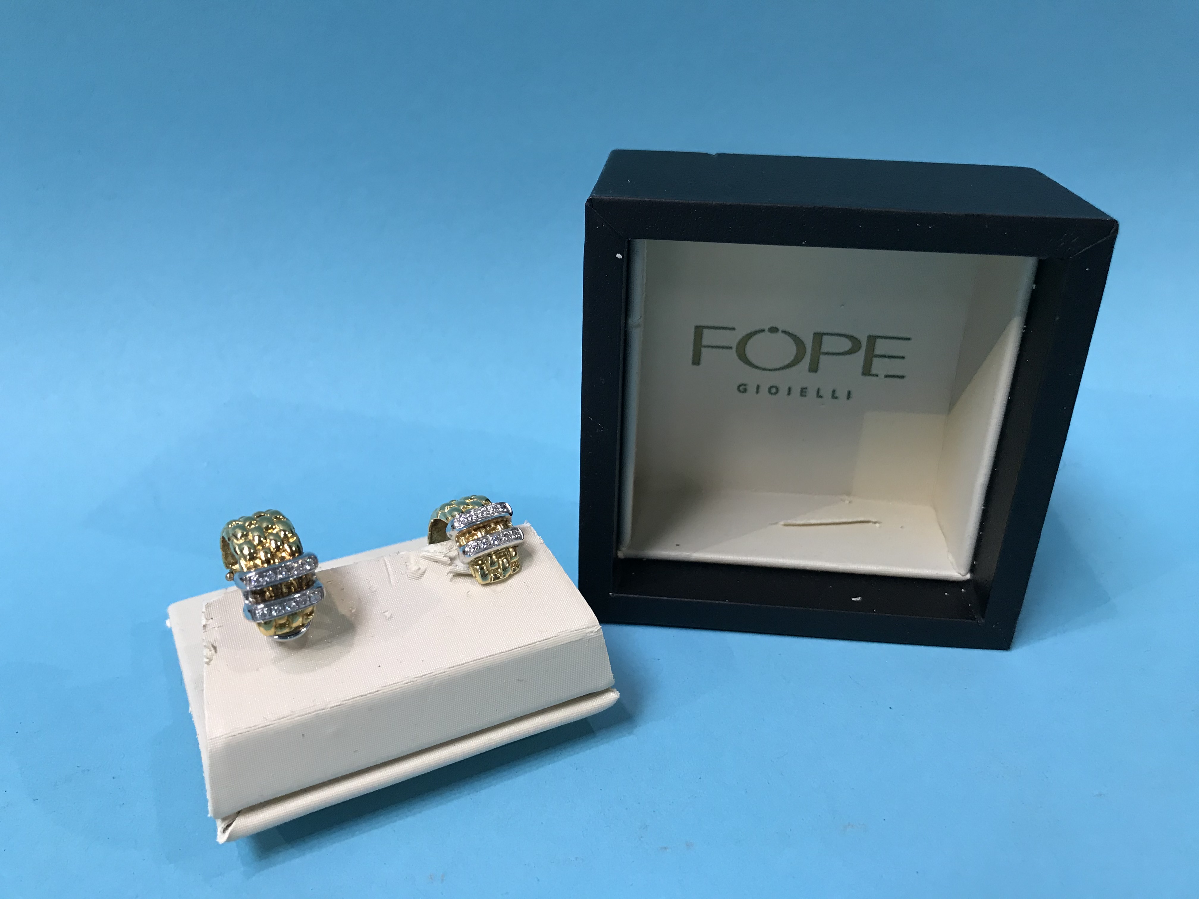 A boxed Fope pair of 18ct gold and diamond earrings, stamped '750' and 'CT 0.09'