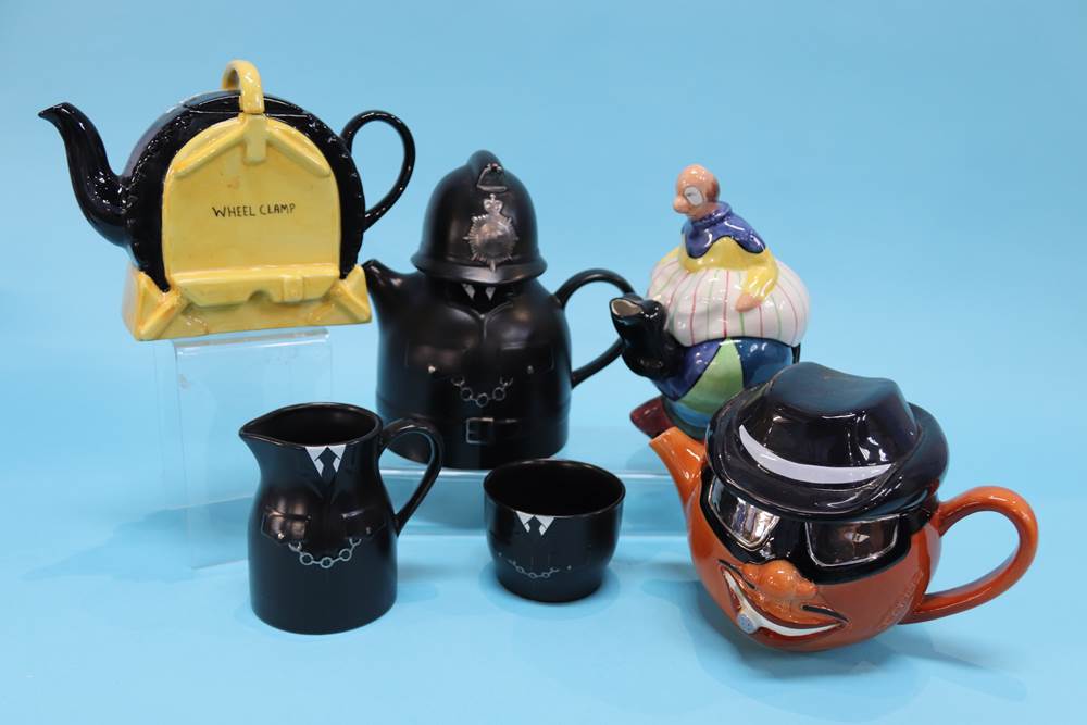 A Carlton Ware 'Wheel Clamp' teapot, Clown teapot and a Policeman with sugar and cream jug