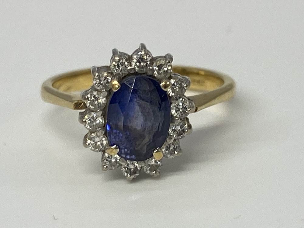 A diamond and sapphire mounted ring and pendant, stamped '750', 5g, size 'L'