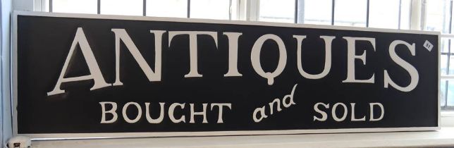 Modern black and white sign 'Antiques Bought and Sold'