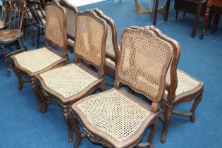 A set of six Continental walnut and bergere chairs