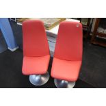 A pair of Johnson design pink chairs, on metal bases