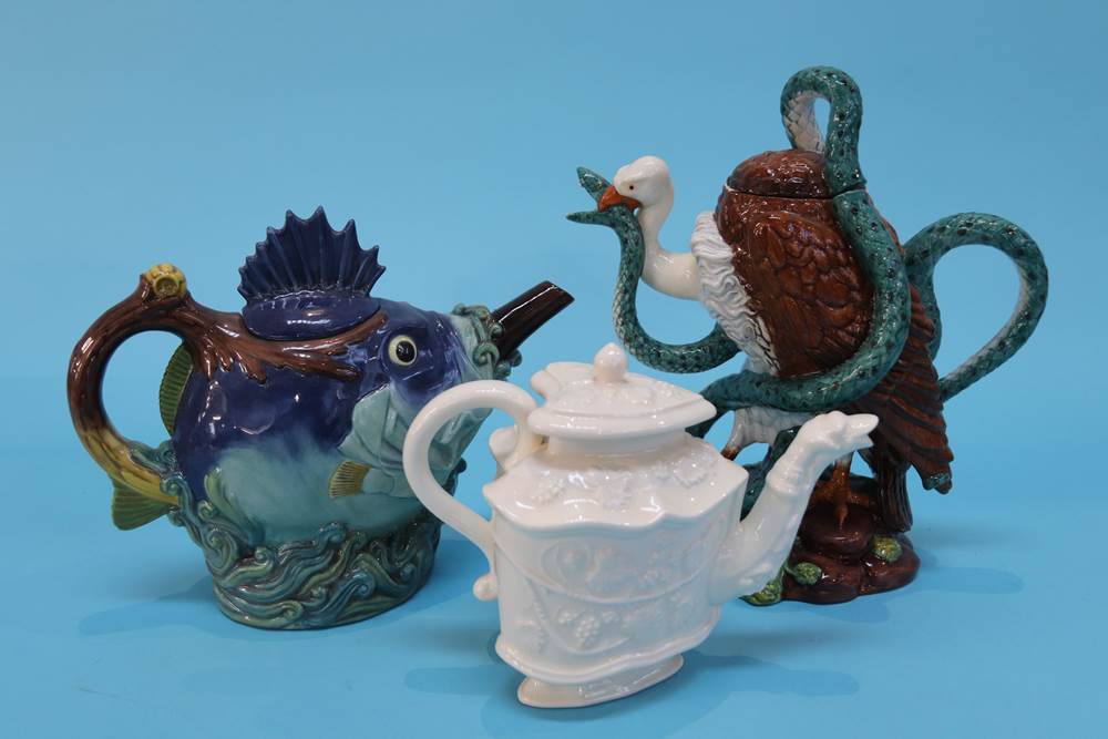 A boxed Minton 'Fish' teapot, a 'Vulture and Python' teapot and a Royal Creamware teapot