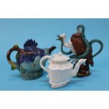 A boxed Minton 'Fish' teapot, a 'Vulture and Python' teapot and a Royal Creamware teapot