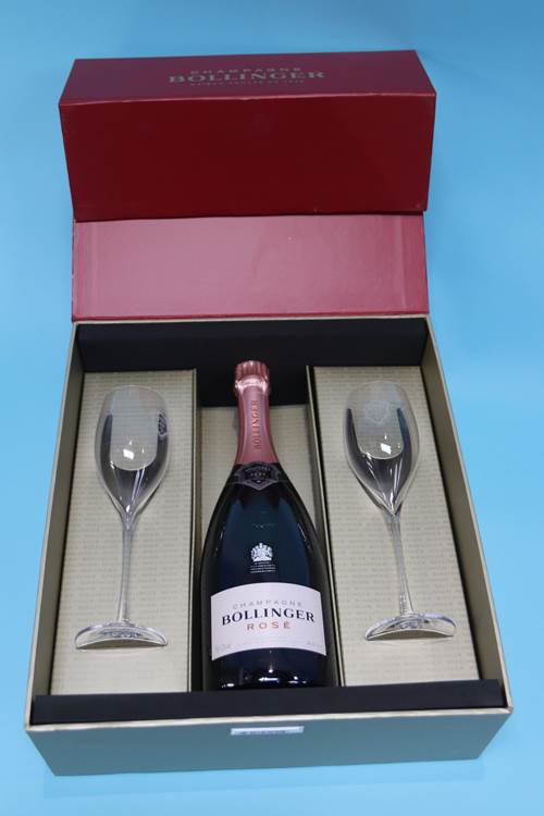 A cased bottle of Bollinger Rose champagne, with two glass flutes