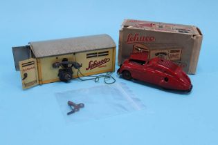 A tinplate Schuco 'Kommando Anno 2000' wind up car and a boxed Schuco garage