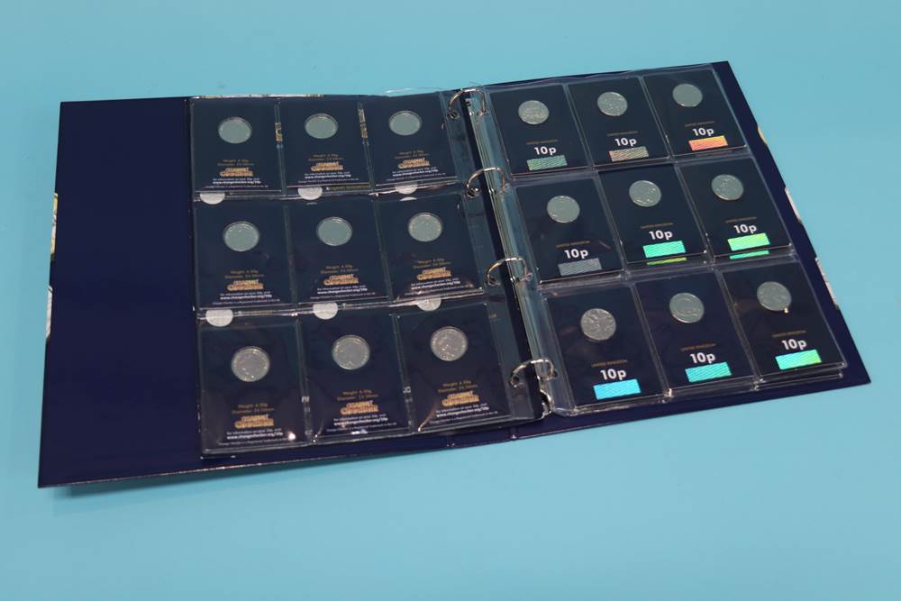 Twenty six 10p alphabet coins complete set, plus completer medallion in change checker album