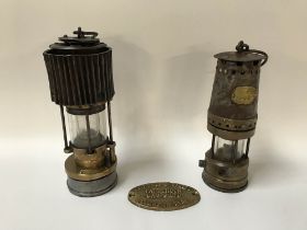 A Patterson Miner's lamp, another Patterson type GTL9 and a small oval Patterson plaque (3)